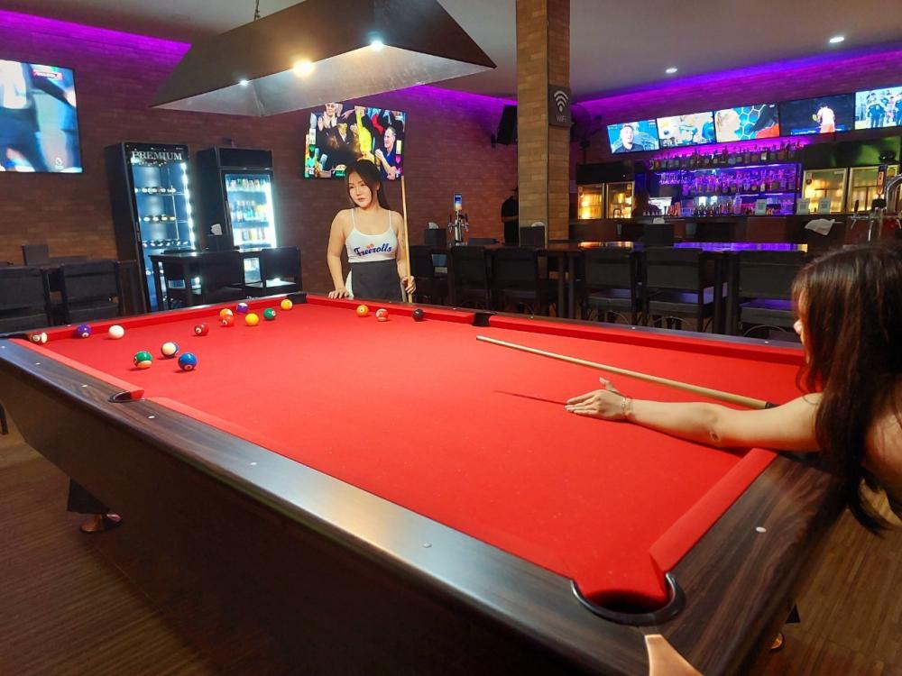Some bars have pool tables or darts